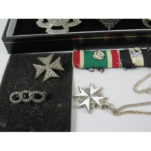 586 - Selection of St Johns Ambulance badges, pips and a sterling silver necklace and pendant.