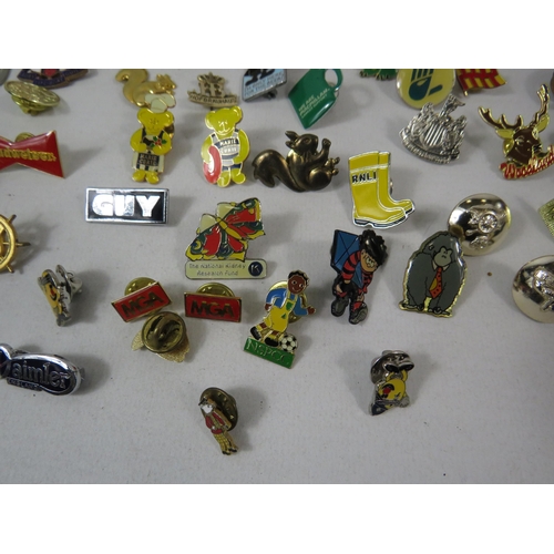 603 - Over 75 various pin badges.