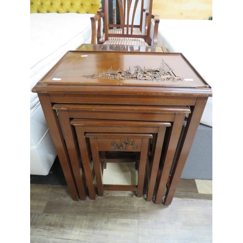 876 - Nest of Four, Oriental style hardwood tables, each with carved oriental decoration to corners and si... 