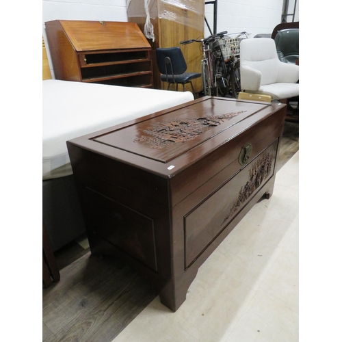 878 - Oriental Hardwood blanket chest with carved decoration showing to tops and sides. Brass lock to fron... 