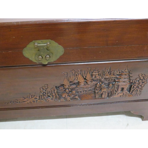 878 - Oriental Hardwood blanket chest with carved decoration showing to tops and sides. Brass lock to fron... 