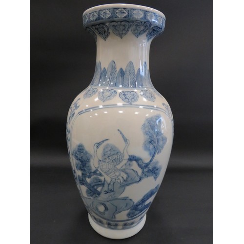 743 - Large blue and white oriental style floor vase decorated with cranes. approx 48cm tall