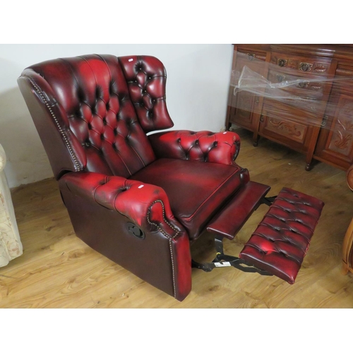 942 - Leather Chesterfield Wing back Armchair manual recliner in Oxblood . Minor scuff/wear to left hand s... 