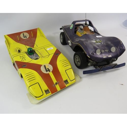 1052 - 2 vintage remote control cars, working condition unknown.