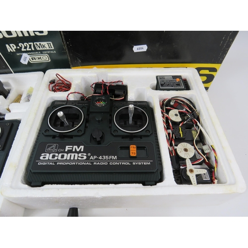 1054 - 2 Acoms Digital radio control systems both appear to be unused in th box, plus one other controller.