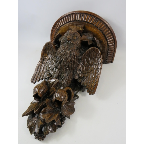 798 - Heavy antique carved oak wall shelf in the form of an owl surrounded by leaves and flowers. 21