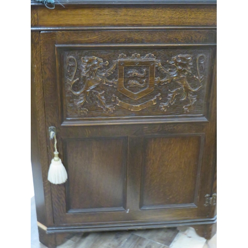 1004 - Unusual good quality darkwood corner unit with leaded glass top section and carved door with coat of... 