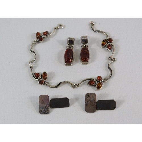 111 - Sterling silver and amber bracelet and a pair of earrings plus a pair of sterling silver cufflinks.