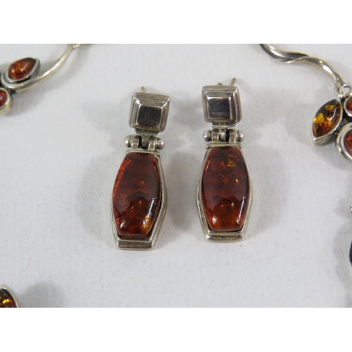 111 - Sterling silver and amber bracelet and a pair of earrings plus a pair of sterling silver cufflinks.