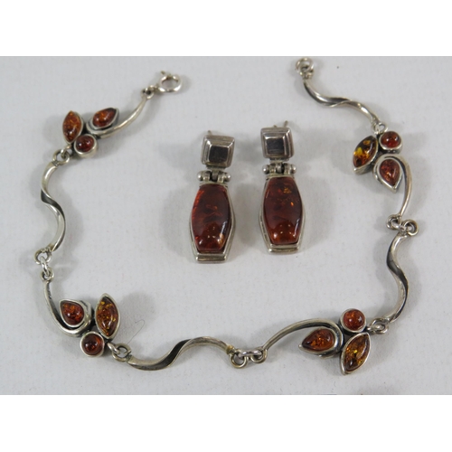 111 - Sterling silver and amber bracelet and a pair of earrings plus a pair of sterling silver cufflinks.