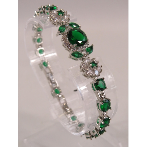 237 - 925 Sterling silver bracelet with green and clear gemstones.