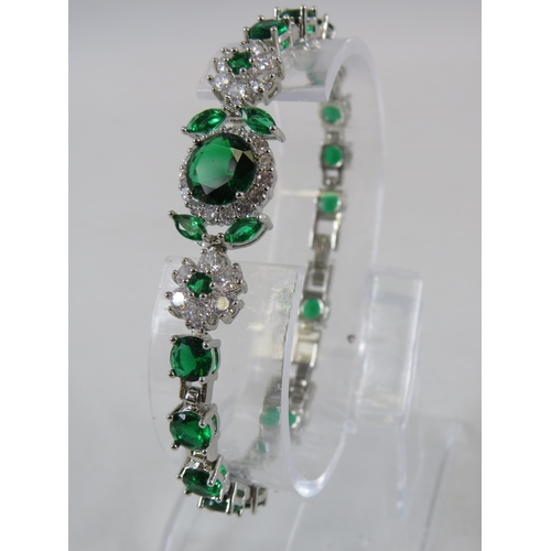 237 - 925 Sterling silver bracelet with green and clear gemstones.