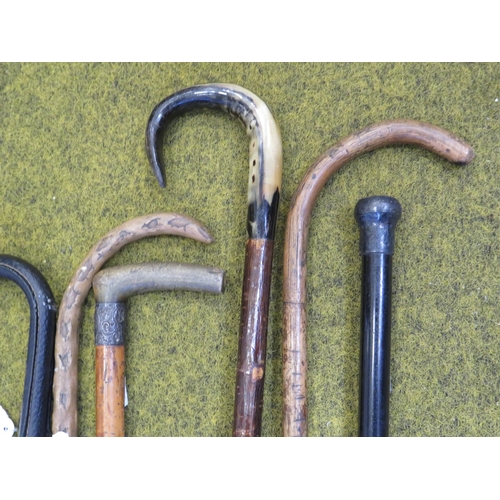 284 - Selection of vintage walking sticks and umbrellas.