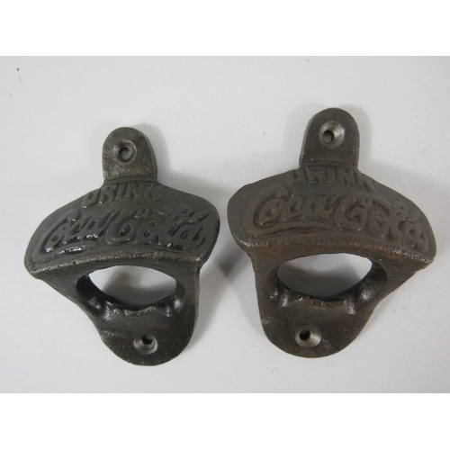 306 - 2 cast metal Coca cola bottle openers.