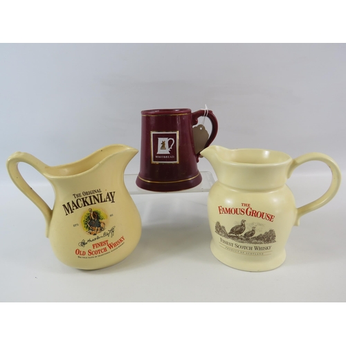 322 - 2 Whiskey advertising jugs and a Whitbread tankard.