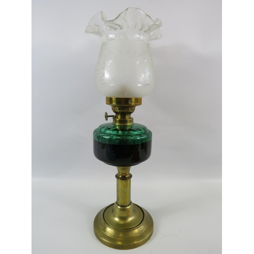 323 - Vintage brass oil lamp with green glass font. Approx 17