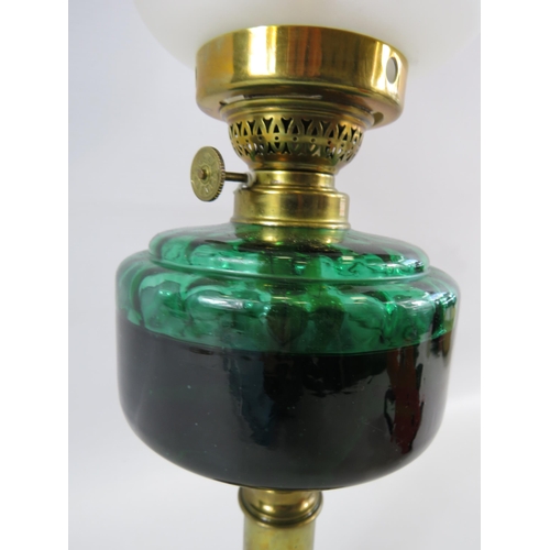 323 - Vintage brass oil lamp with green glass font. Approx 17