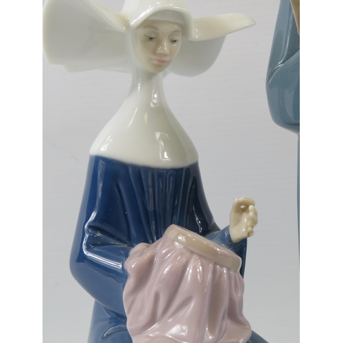 325 - 2 Lladro nun figurines. The tallest measures 10