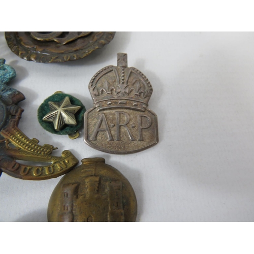 179 - Selection of Military items, Silver ARP Badge, Cap badges, buttons, shell cases etc. see photos.