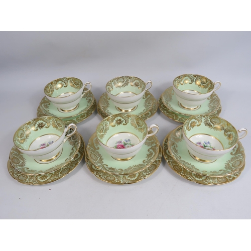 253 - 6 Paragon china trios, green and gilt with floral decoration.