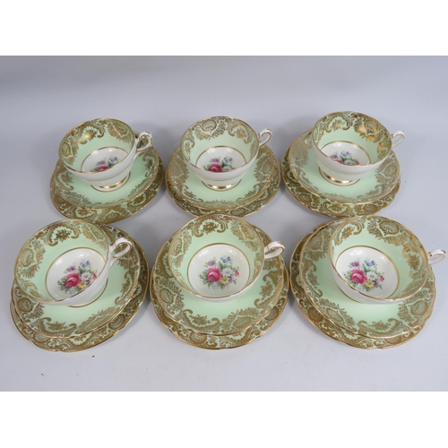 253 - 6 Paragon china trios, green and gilt with floral decoration.