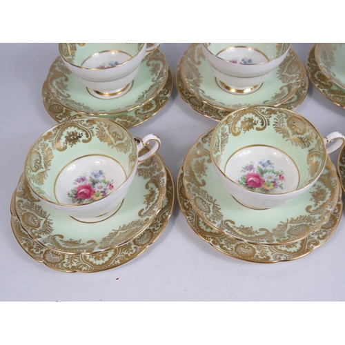 253 - 6 Paragon china trios, green and gilt with floral decoration.