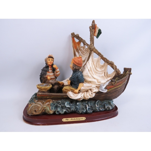 271 - Resin sculpture of a boat and fishermen. Aprrox 28cm tall and 34cm long.