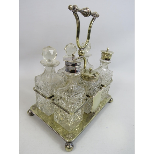 272 - 6 piece glass cruet condiment set in silver plated stand.