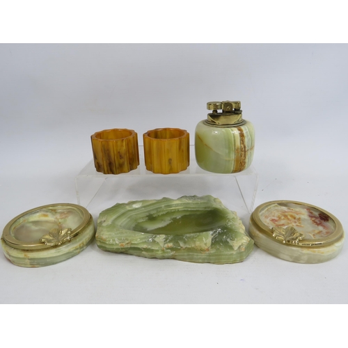 276 - A pair of butterscotch bakelite napkin rings and a selection of Oynx ashtrays, table lighter etc