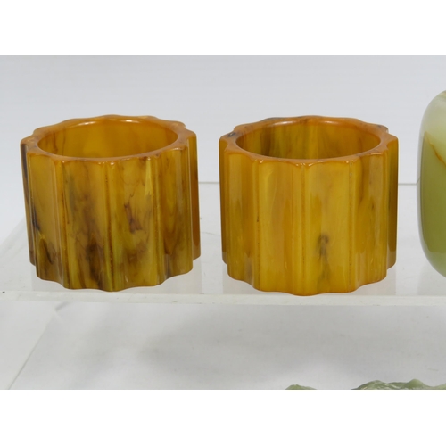 276 - A pair of butterscotch bakelite napkin rings and a selection of Oynx ashtrays, table lighter etc