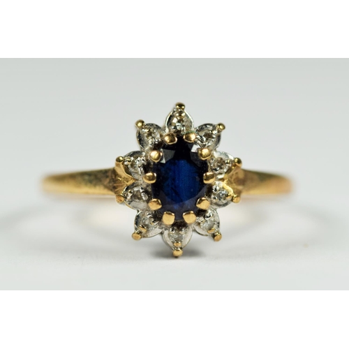 242 - 9ct white and yellow gold diamond and sapphire oval halo cluster dress ring (1.6g)     2041305
