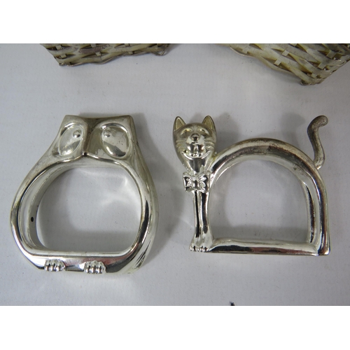 99 - 2 Sets of white metal napkin rings in the form of Cats and owls sat in carrying baskets.