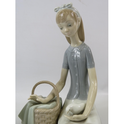 1 - 2 Nao Lladro figurines, a girl with a doll and a girl with a basket of flowers and a bird the talles... 