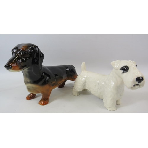 56 - Beswick Dachshund and Sealyham Terrier figurines.