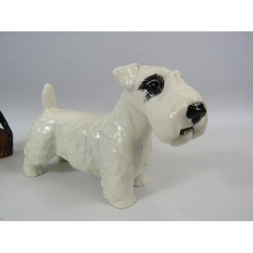 56 - Beswick Dachshund and Sealyham Terrier figurines.