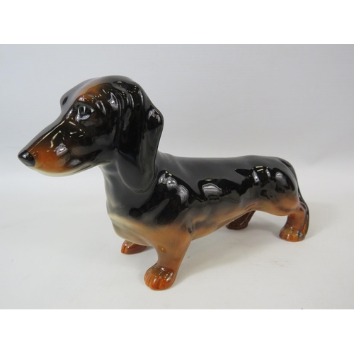 56 - Beswick Dachshund and Sealyham Terrier figurines.