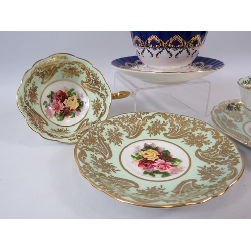 61 - 2 Paragon cabinet cups and saucer with Rose pattern centres plus one by Aynsley.