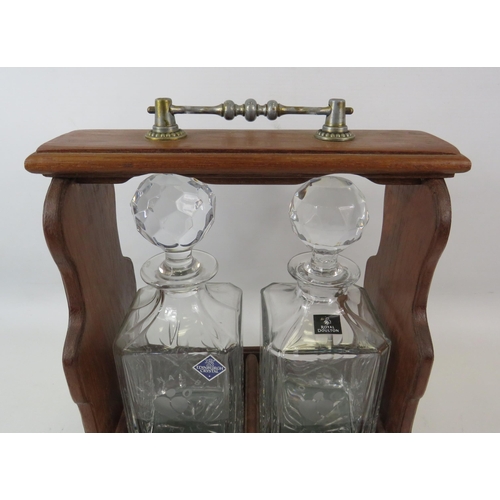 70 - Vintage Tantalus with brass detail and a pair of national blood service decanters.