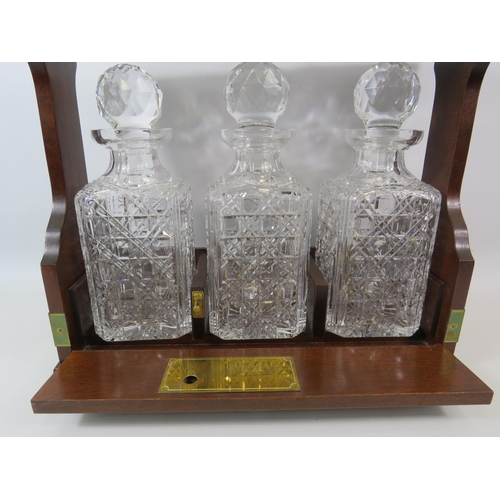 71 - Vintage Oak and brass Tantalus and 3 matching crystal glass decanters, 13.5