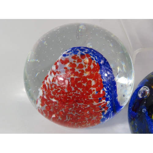 93 - 6 Blue, red, yellow coloured paperweights.