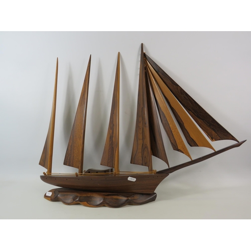 125 - Large solid wood boat sculpture which measures 27