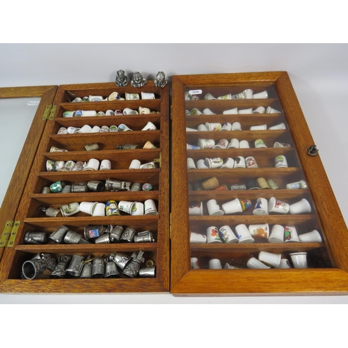 179 - Large selection of various ceramic and pewter and ceramic thimbles in 2 glass display cases.