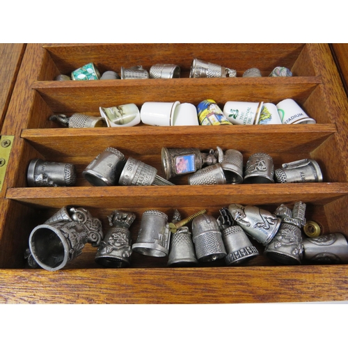 179 - Large selection of various ceramic and pewter and ceramic thimbles in 2 glass display cases.