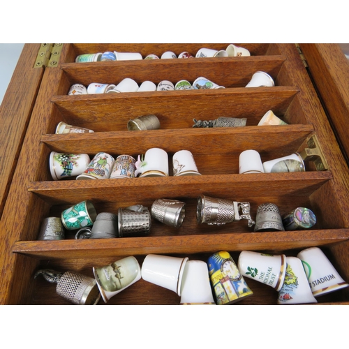 179 - Large selection of various ceramic and pewter and ceramic thimbles in 2 glass display cases.