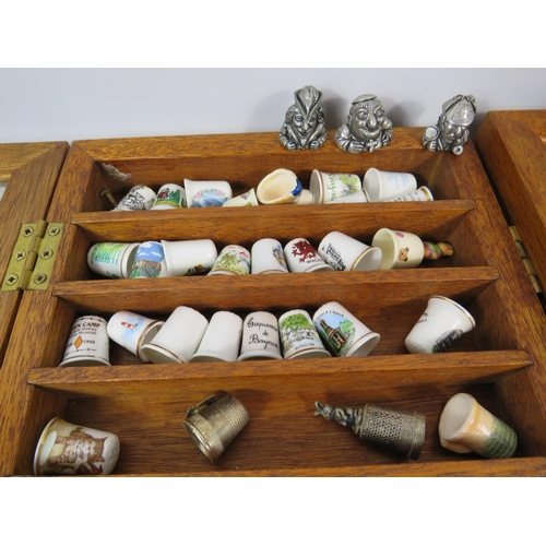 179 - Large selection of various ceramic and pewter and ceramic thimbles in 2 glass display cases.