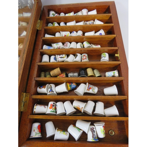 179 - Large selection of various ceramic and pewter and ceramic thimbles in 2 glass display cases.