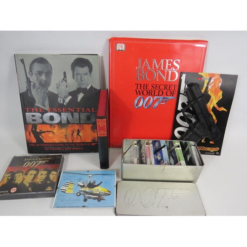 1731 - Assorted James Bond Items, Books to include an Ian Fleming Copy, Signed picture by Ken Wallace plus ... 