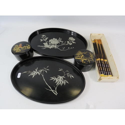 1599 - 2 Oriental trays, 2 sets of coasters in trinket boxes and a selection of chop stix.