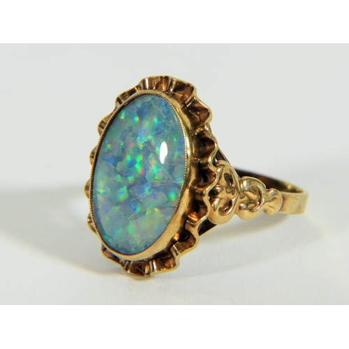 311 - Yellow metal ring (testing 9ct) set with large reconstitued Opal which measures 20 x 14 mm  Finger s... 