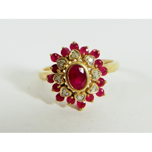 313 - 9ct Yellow Gold Diamond and Ruby set Flower pattern ring. Finger size 'P'  3.9g